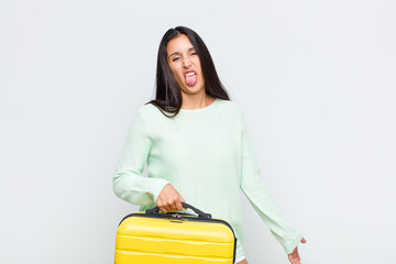 pretty woman feeling disgusted and irritated, sticking tongue out, disliking something nasty and...