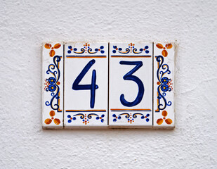 Fototapeta premium Street sign number 43 on a white wall 