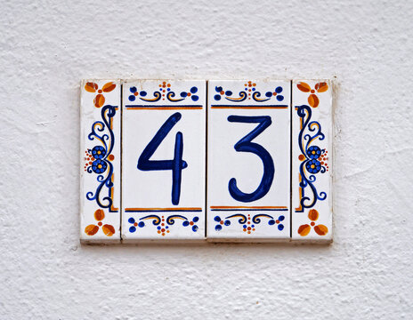 Street sign number 43 on a white wall 