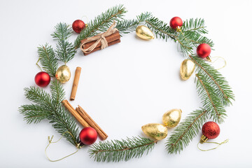 Christmas or New Year wreath composition. Decorations, balls, fir and spruce branches, on white background. Side view, copy space.