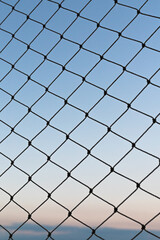 Fototapeta premium Evening seen through a window with safety net