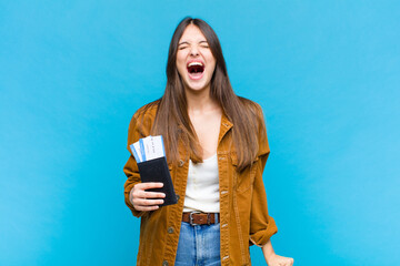 pretty woman shouting aggressively, looking very angry, frustrated, outraged or annoyed, screaming...