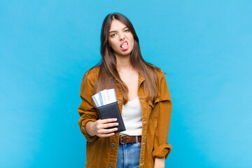 pretty woman feeling disgusted and irritated, sticking tongue out, disliking something nasty and...