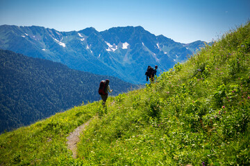 Fototapeta na wymiar Beautiful mountain landscape with tourists hiking at Caucasus mountains.