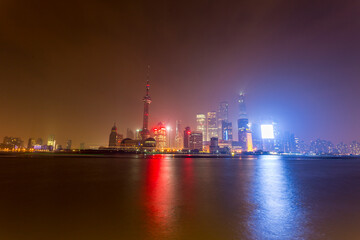 Fototapeta na wymiar Shanghai skyline at night with river and lights