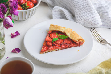 Slice Of Sweet Fresh Baked Strawberry Galette With Mint Leaves On White Plate