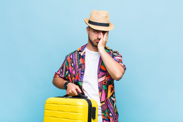 young man feeling bored, frustrated and sleepy after a tiresome, dull and tedious task, holding...