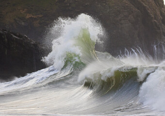 Stormy and powerful waves crash against the cliffs of Cape Disappointment