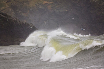 Stormy and powerful waves crash against the cliffs of Cape Disappointment