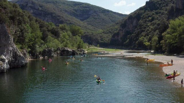 Aerial Shot of Pont D'Arc in Southern France, kayaks riding down the Ardeche river in south of france