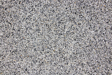 Close up concrete tiny gravel stone wall texture background, There are black, white, gray and orange pebble stones. (for use background)