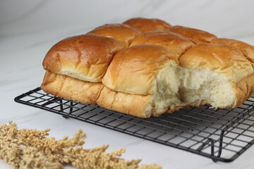 Roti Sobek or Pull Out Soft bread on black cooling rack. Isolated white background.