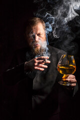 Solid confident bearded man in suit with glass of whisky and cigar with fume