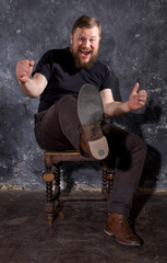 Mature bearded man dressed in t-shirt kicking