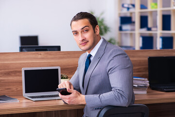 Young male employee working in the office