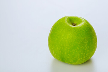 Whole sour green apple isolated on white background.