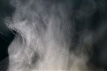 Grey smoke on a black background, fog on a dark background