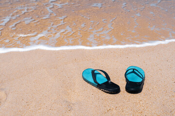 Slippers on the sand at the sea with space , summer holiday and vacation.