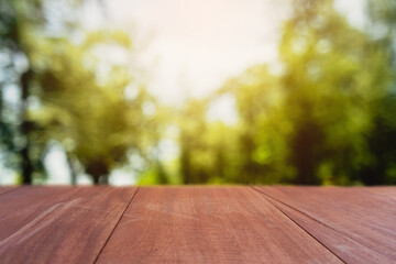 Selective focus of empty old wood on blur nature green leaf with bokeh.