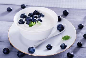 yogurt and blueberry on white wooden table. Healthy аnd tasty  breakfast