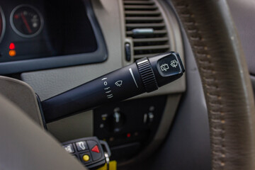 Switch off lights in a car. close-up Car integrated turning indicator with headlight switch toggle.