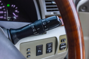 Switch off lights in a car. close-up Car integrated turning indicator with headlight switch toggle.