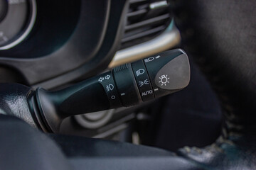 Switch off lights in a car. close-up Car integrated turning indicator with headlight switch toggle.