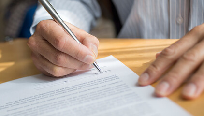 A hand of a man holding a pen signing a letter. Contract . Agreement. Declaration.