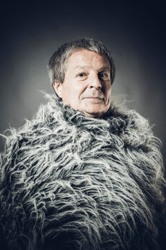 Solid middle-aged man in a fur mantle
