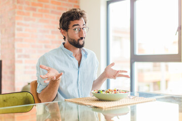 bearded man feeling puzzled and confused, doubting, weighting or choosing different options with...