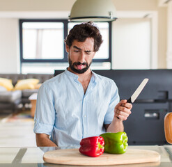 bearded man with cheerful, carefree, rebellious attitude, joking and sticking tongue out, having fun