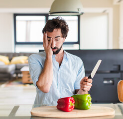 bearded man feeling bored, frustrated and sleepy after a tiresome, dull and tedious task, holding...
