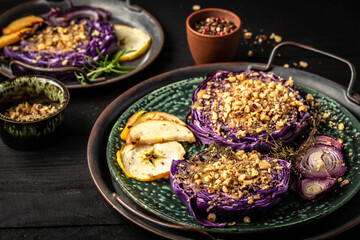 Vegan roasted red cabbage steaks with nuts, quince, onions and apples Top view, flat lay