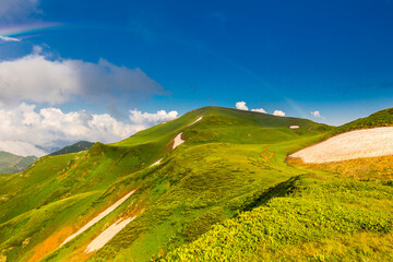 Beautiful mountain landscape at Caucasus mountains with clouds and blue sky