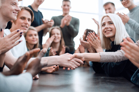 group of young people applauding the participants of the meeting