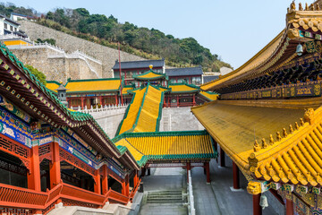 Fototapeta na wymiar Chinese traditional royal style colorful temples in the Putuoshan mountains, Zhoushan Islands, a renowned site in Chinese bodhimanda of the Guanyin