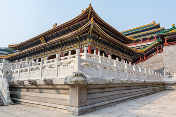 Fototapeta premium Architectural details of Chinese traditional royal style colorful Baoxiang lecture temples in the Putuoshan mountains, Zhoushan Islands, a renowned site in Chinese bodhimanda of the Guanyin