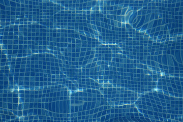 Small blue tiles in the pool. The bottom of the pool is visible through the clear water....