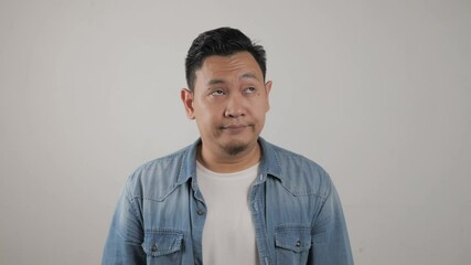 Young Asian man closing his ears dont want or avoiding to hear bad news, stress under mental pressure