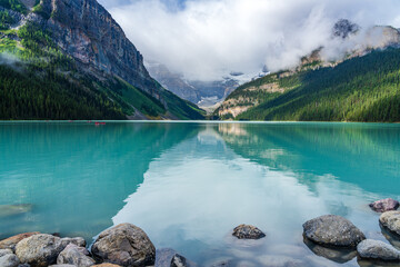 Lake Louise in summer sunny day morning. Blue sky and white clouds reflected on the turquoise color...