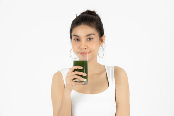 Beautiful young Asian woman drinking green detox vegetable smoothie over white isolated background. Fitness and health care concept, Vegetarian drink juice, Healthy lifestyle.