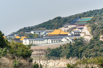 Chinese traditional colorful temples in the Putuoshan mountains, Zhoushan Islands,  a renowned site in Chinese bodhimanda of the bodhisattva Avalokitesvara (Guanyin)
