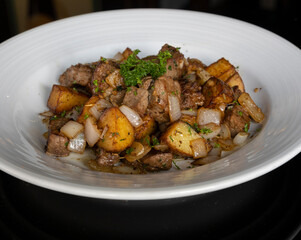 Steak and potato skillet with beef, roasted potatoes, onions and garlic butter