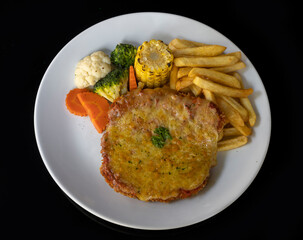 Chicken Parmigiana with vegetables and French fries
