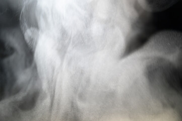 Grey smoke on a black background, fog on a dark background