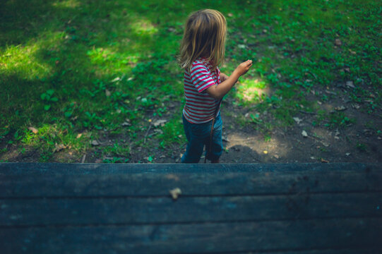 Preschooler by picnic table in the forest