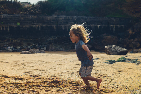 Preschooler running on the beach