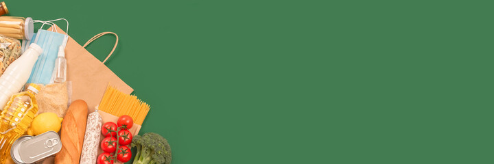 Banner. Flat lay composition with food and medicines donations on green background with copyspace -...