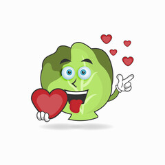 Cabbage mascot character holding a love icon. vector illustration