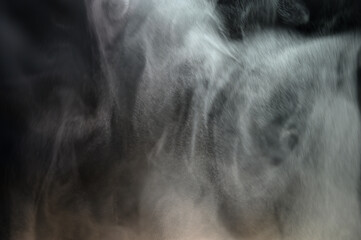 Grey smoke on a black background, fog on a dark background